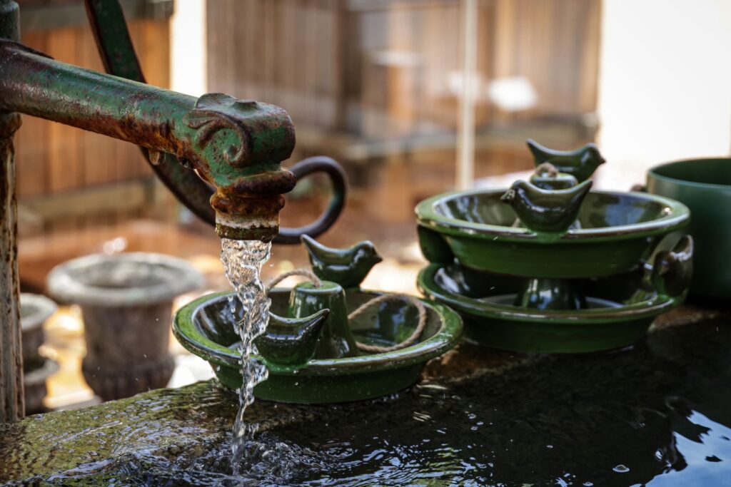 A small tiered fountain with running water