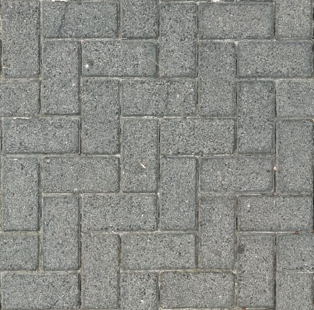 Gray concrete pavers laid in a herringbone pattern